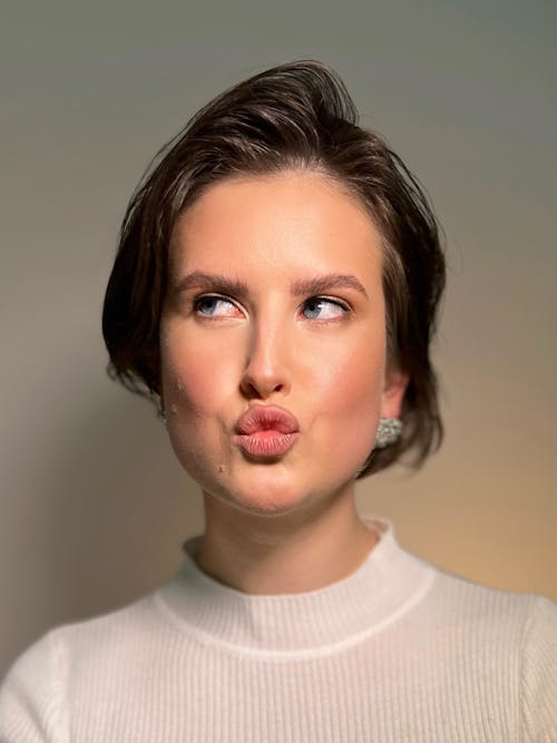 Studio Portrait of a Young Woman Making a Kissing Face