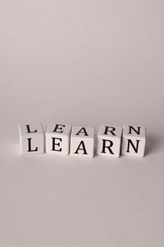 Close-up of letter blocks spelling 'LEARN' on a clean white background, emphasizing education.