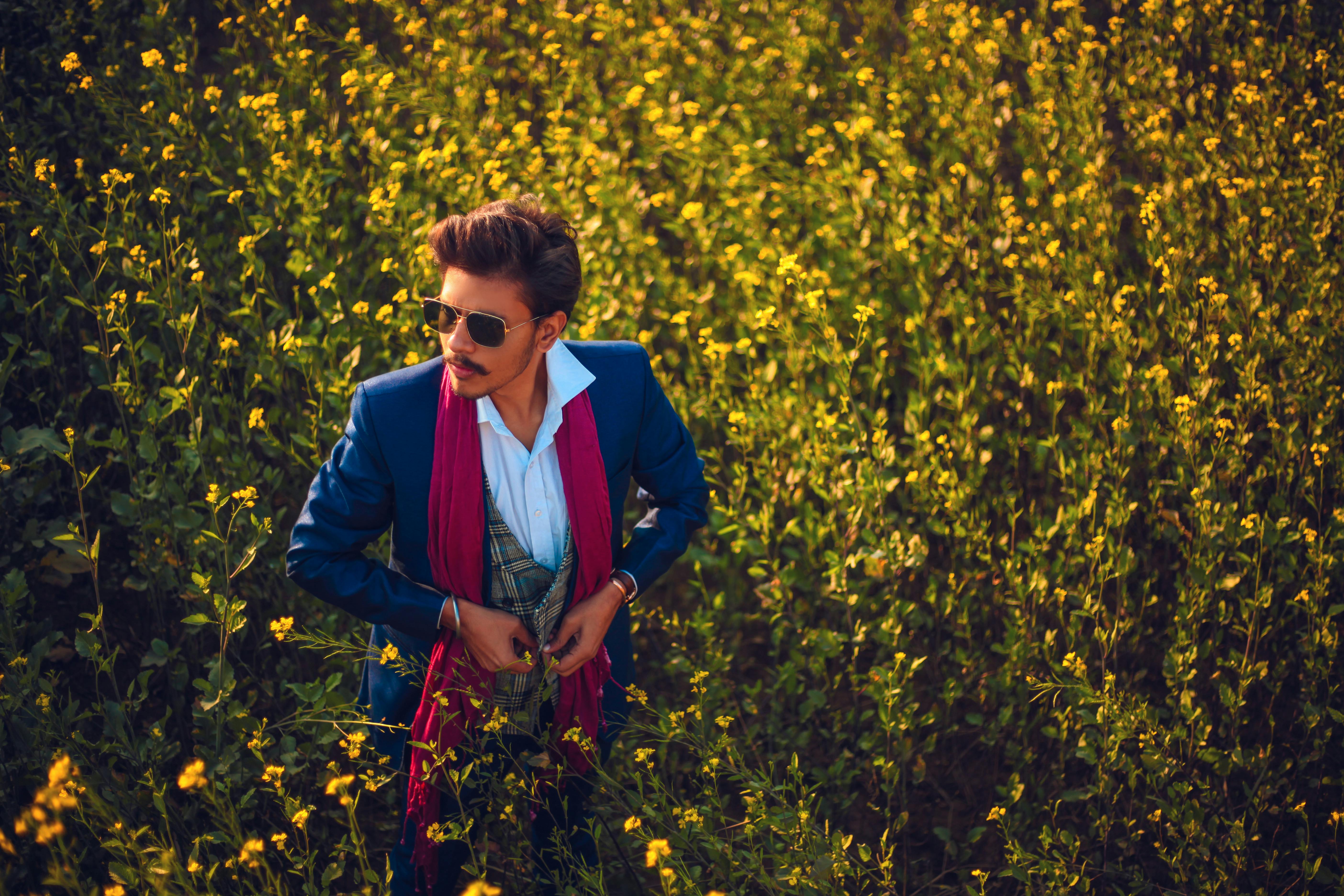 Free Man Standing in the Middle of Yellow Flower Field Stock Photo