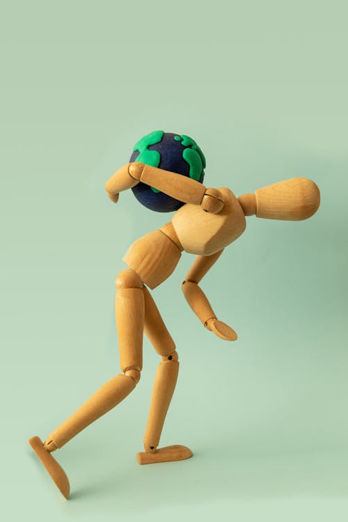 Wooden Figurine Holding a Globe 