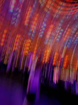 Colorful and dynamic abstract light patterns create a sense of motion and energy.