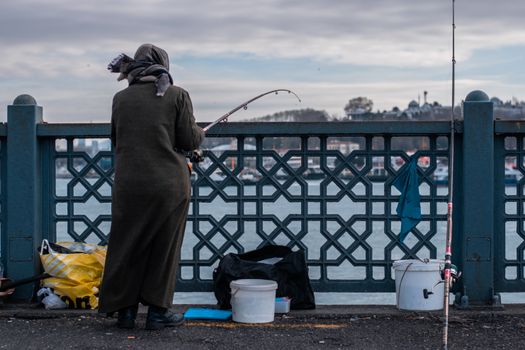 Woman Fishing on Waterfront
