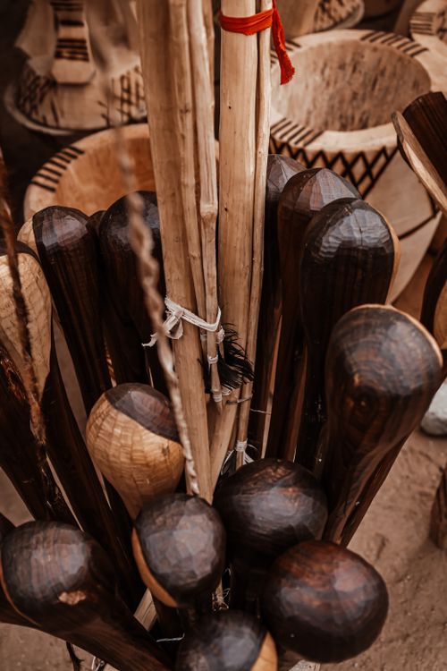 Free Close-up of handcrafted wooden drums and sticks in Angola. Warm tones and detailed textures. Stock Photo