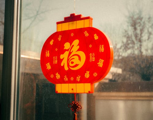 Close-up of a Decoration in a Shape of a Traditional Red Lantern Hanging on a Window 