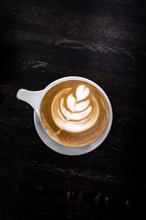 Free Cup of Coffee on a Dark Wooden Surface Stock Photo