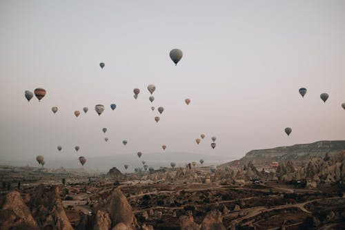 Hot Air Balloons Floating Over Rock Formations