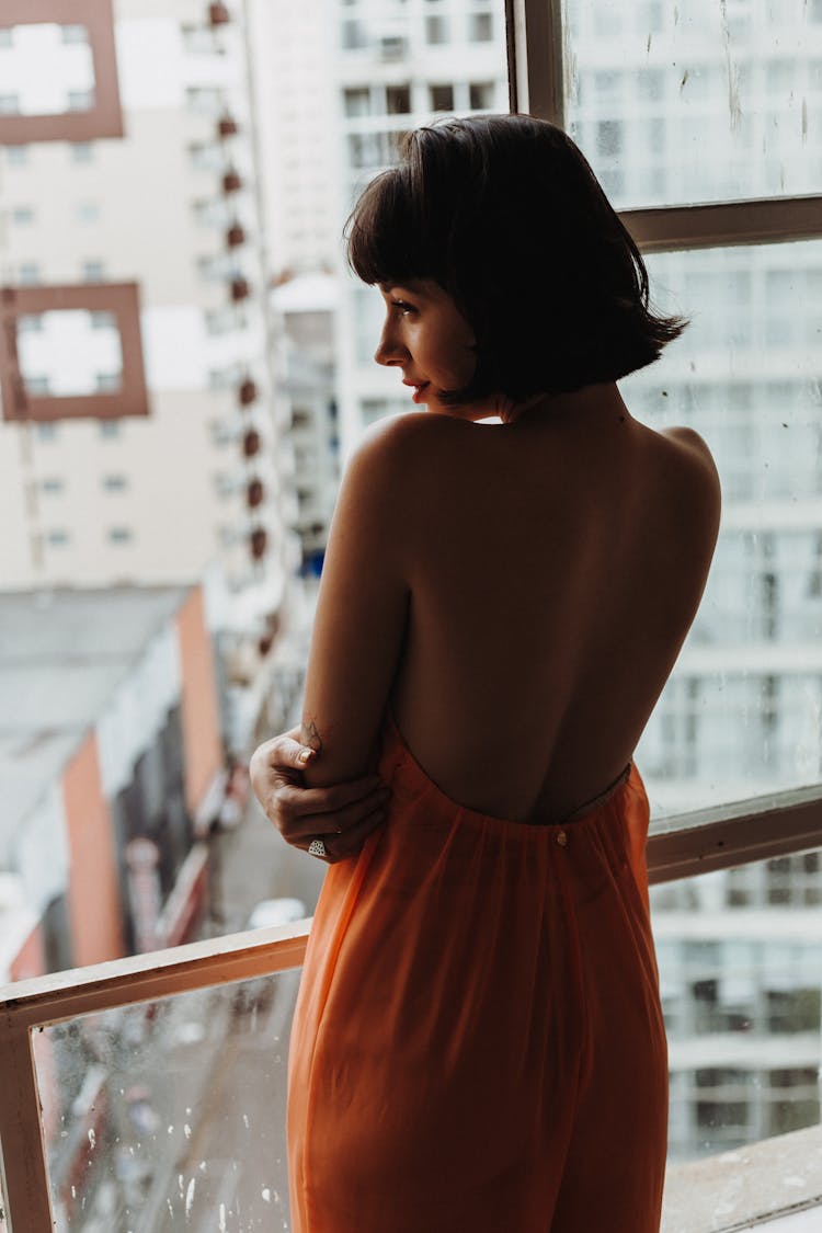 Woman Standing On Building Balcony