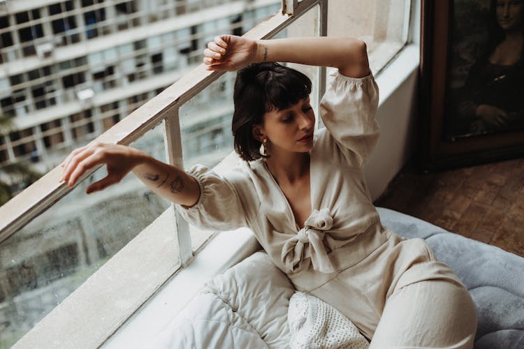 Woman Lying On Building Balcony