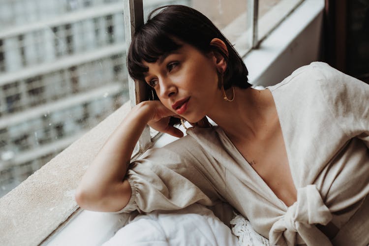 Woman Lying Near Window Looking Outside