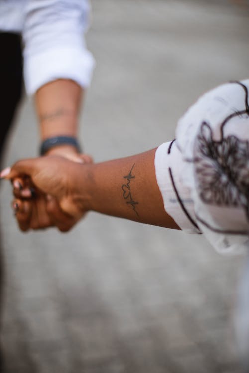 Tattooed Couple Holding Hands 