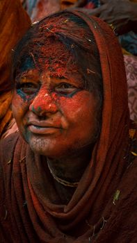 Close-up portrait of a woman covered in Holi colors, showcasing Indian traditional celebration.