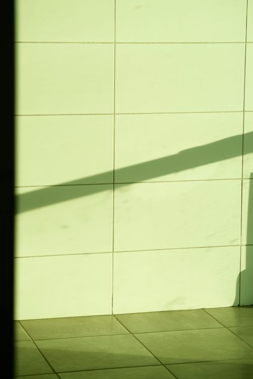 Free Abstract play of light and shadow on a minimalist white tiled wall, creating a unique visual. Stock Photo