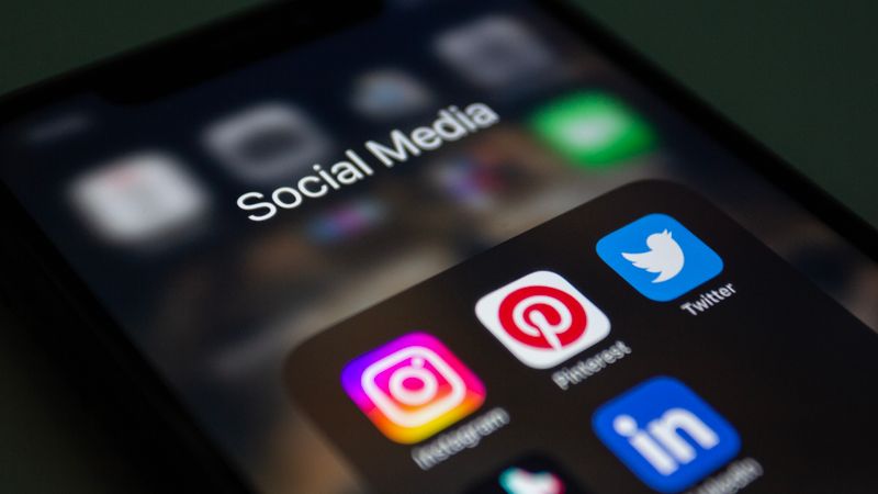 Close-up of a smartphone screen showing a folder of social media apps