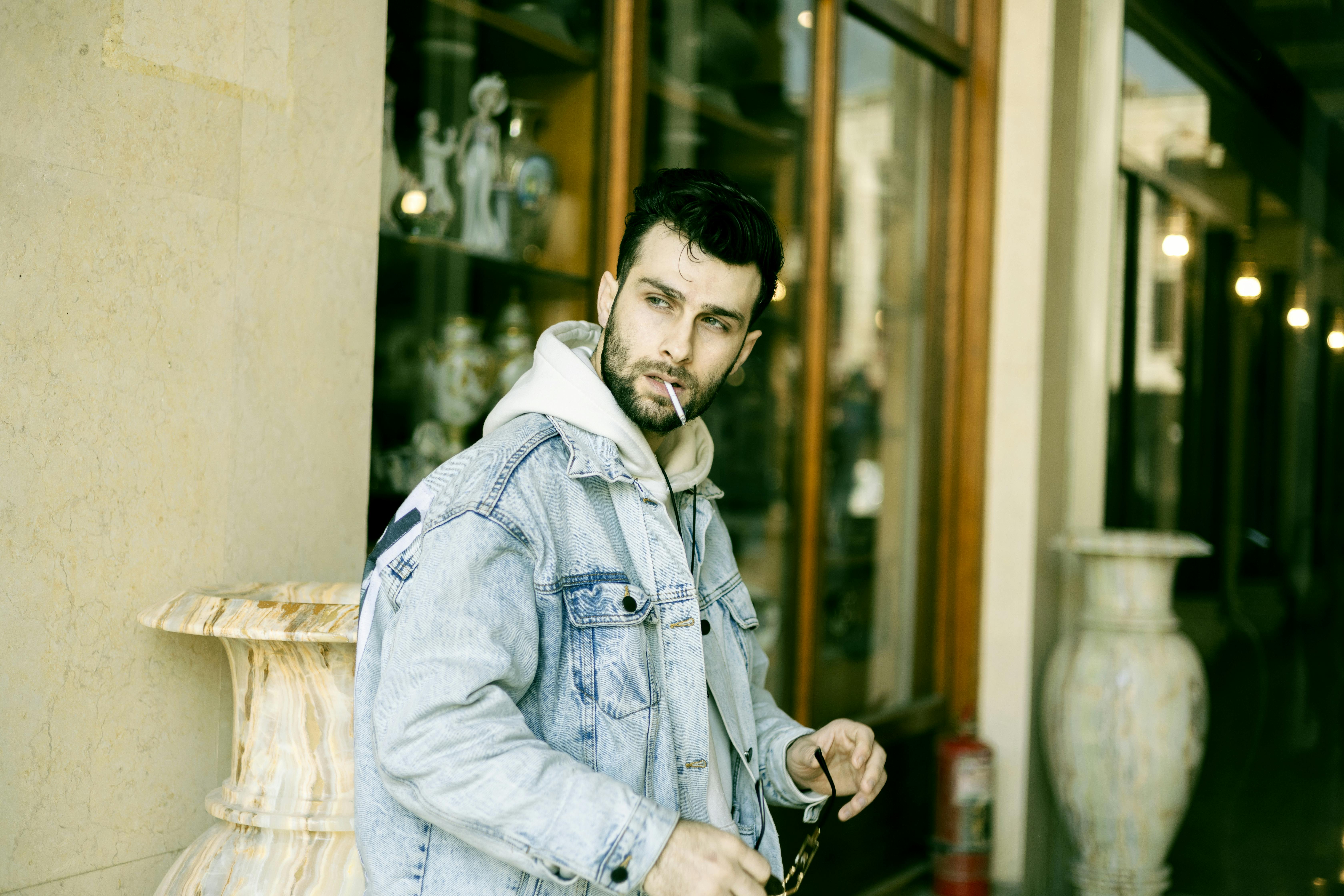 Fashionable man wearing denim jacket, representing target demographic for jeans wear testing