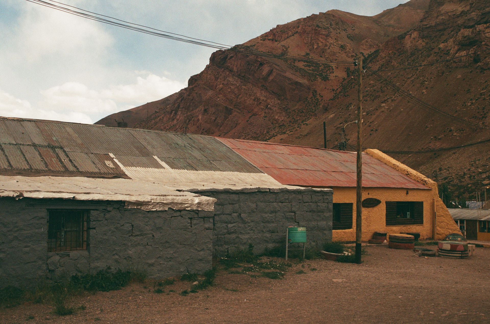 Abandoned Buildings near Hill with Rocks