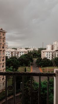 View of a townscape in Angola under an overcast sky, featuring trees and buildings.