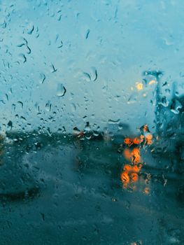 Raindrops on a window creating a blurred cityscape in Belo Horizonte.