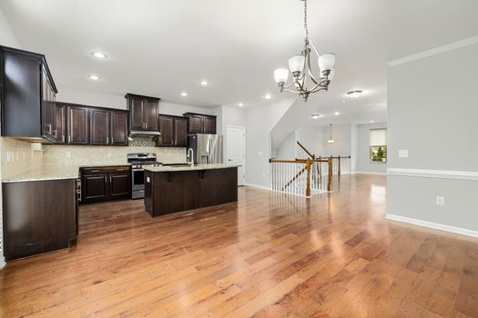 Spacious open-plan kitchen and living area with modern design and wooden floor.
