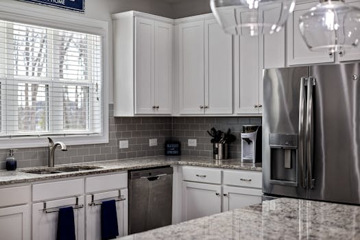 Chic modern kitchen featuring white cabinets and stainless steel appliances for a contemporary look.