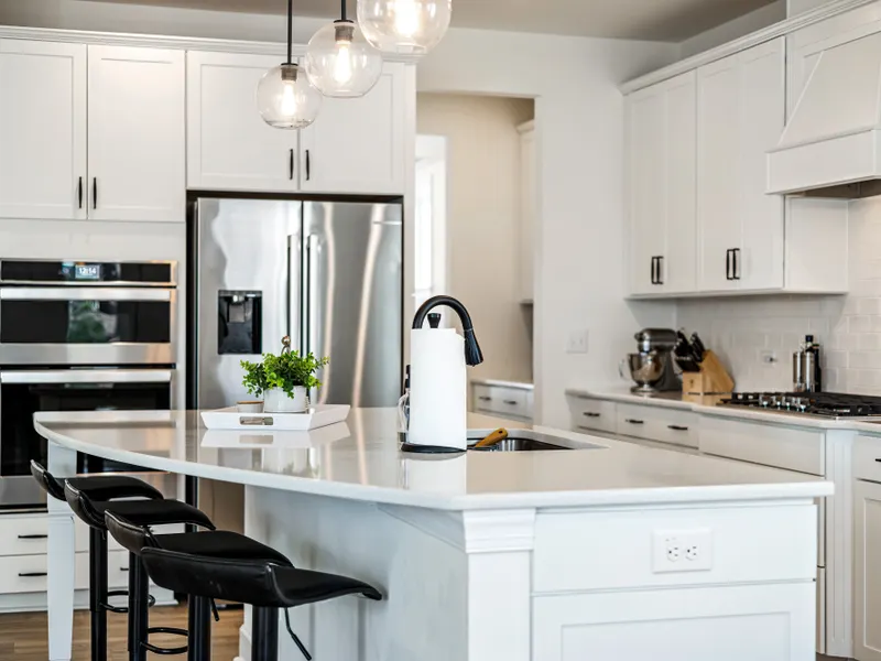 Modern kitchen with white cabinets, lighting and stainless steel appliances Modern kitchen with white cabinets, lighting and stainless steel appliances