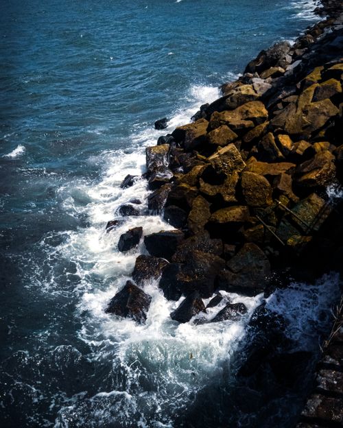 Free Dramatic waves crashing against rocky shoreline in Puerto Montt, Chile. Stock Photo