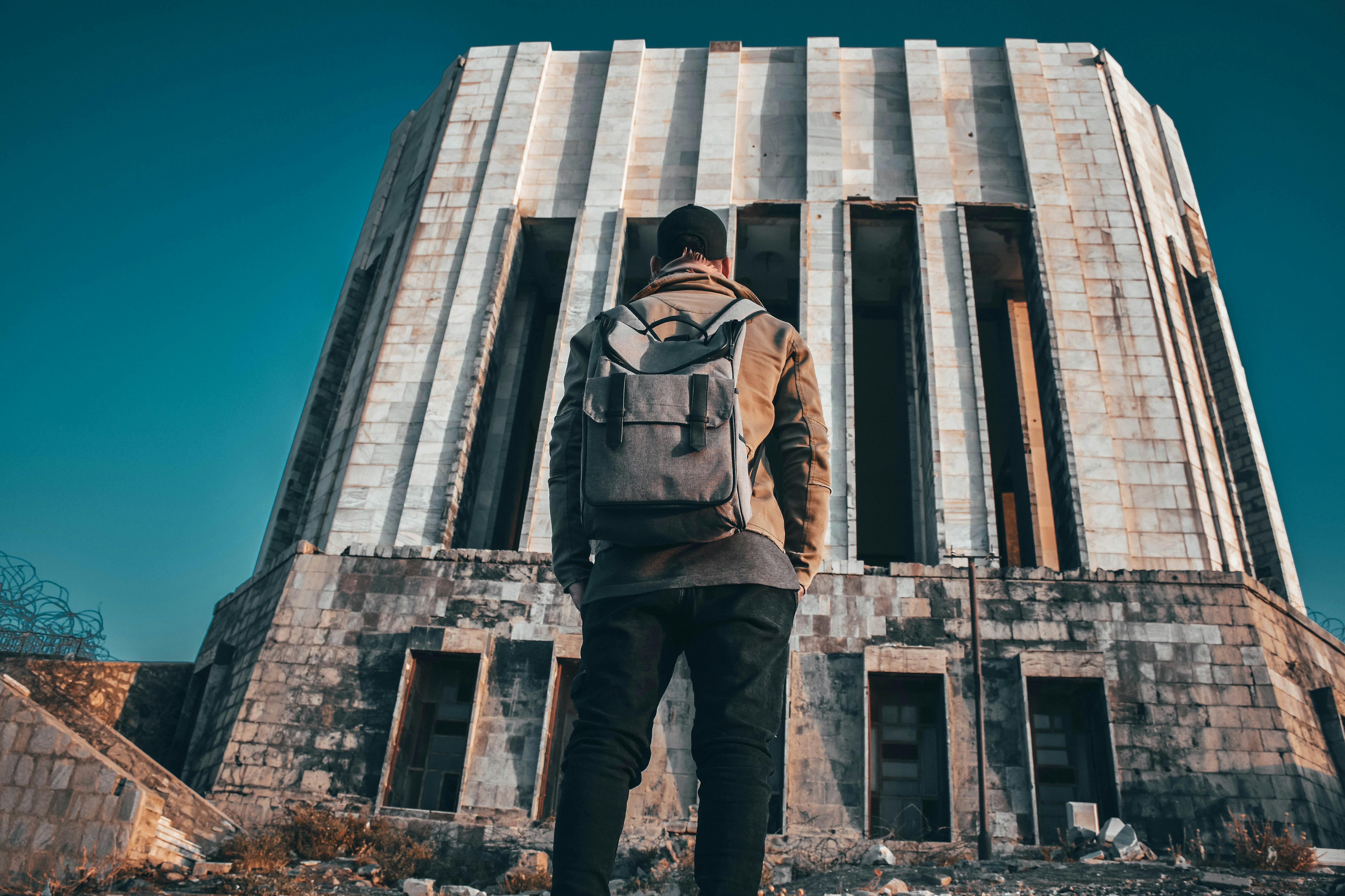 man standing in front of the building