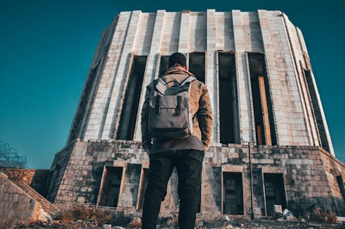 Man Standing In Front of the Building