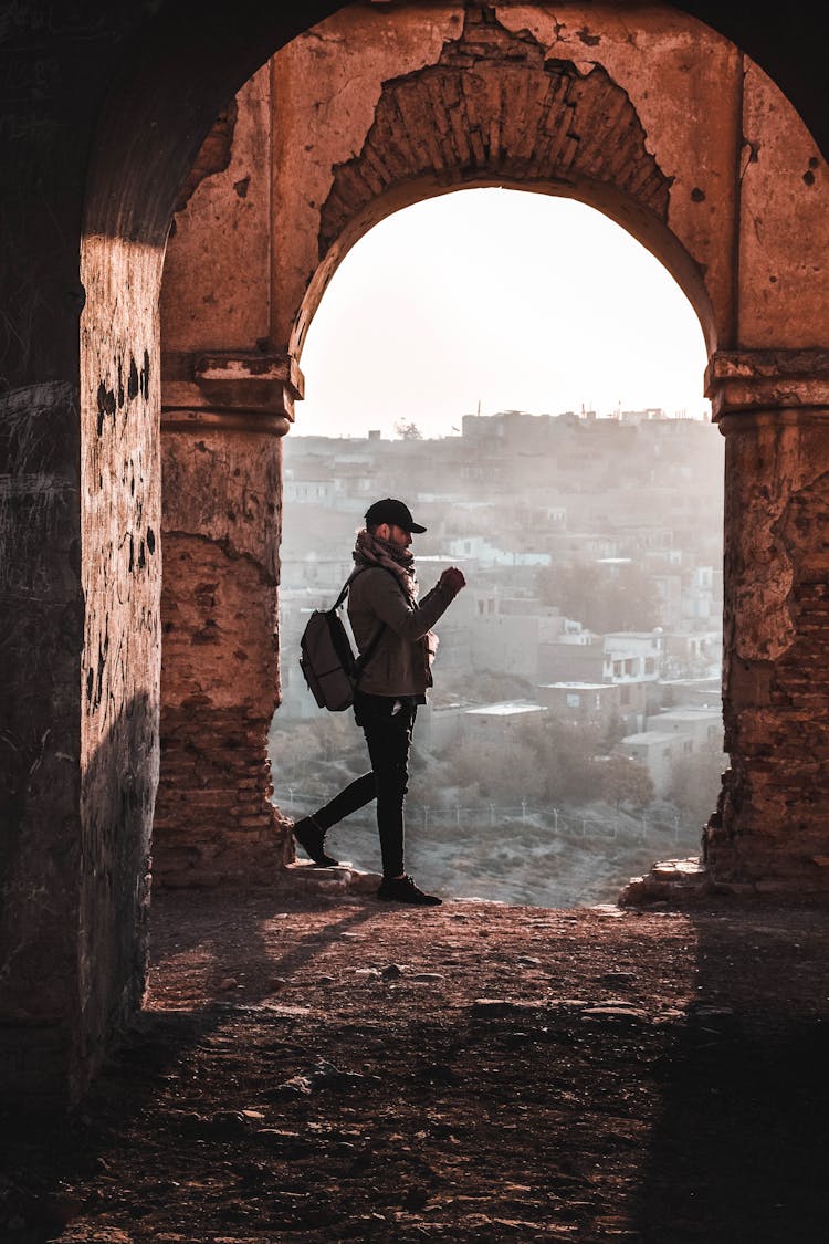 Man Standing Under Arch