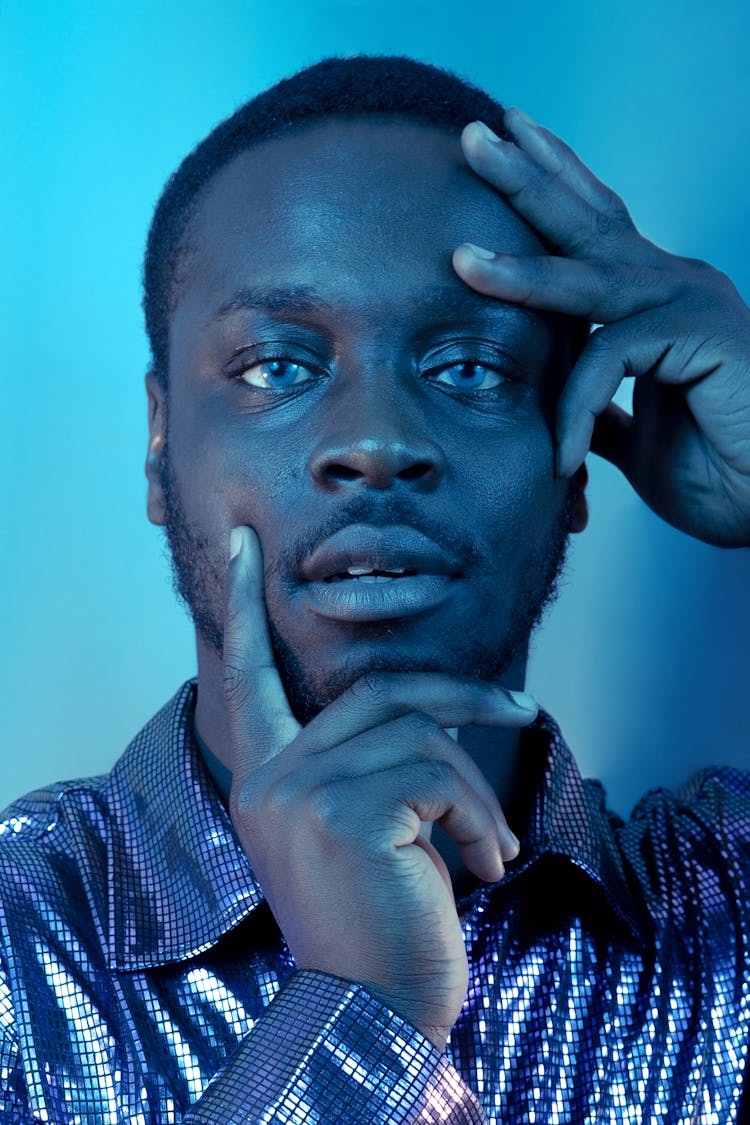 Young Man In Glitter Shirt In Blue Lights