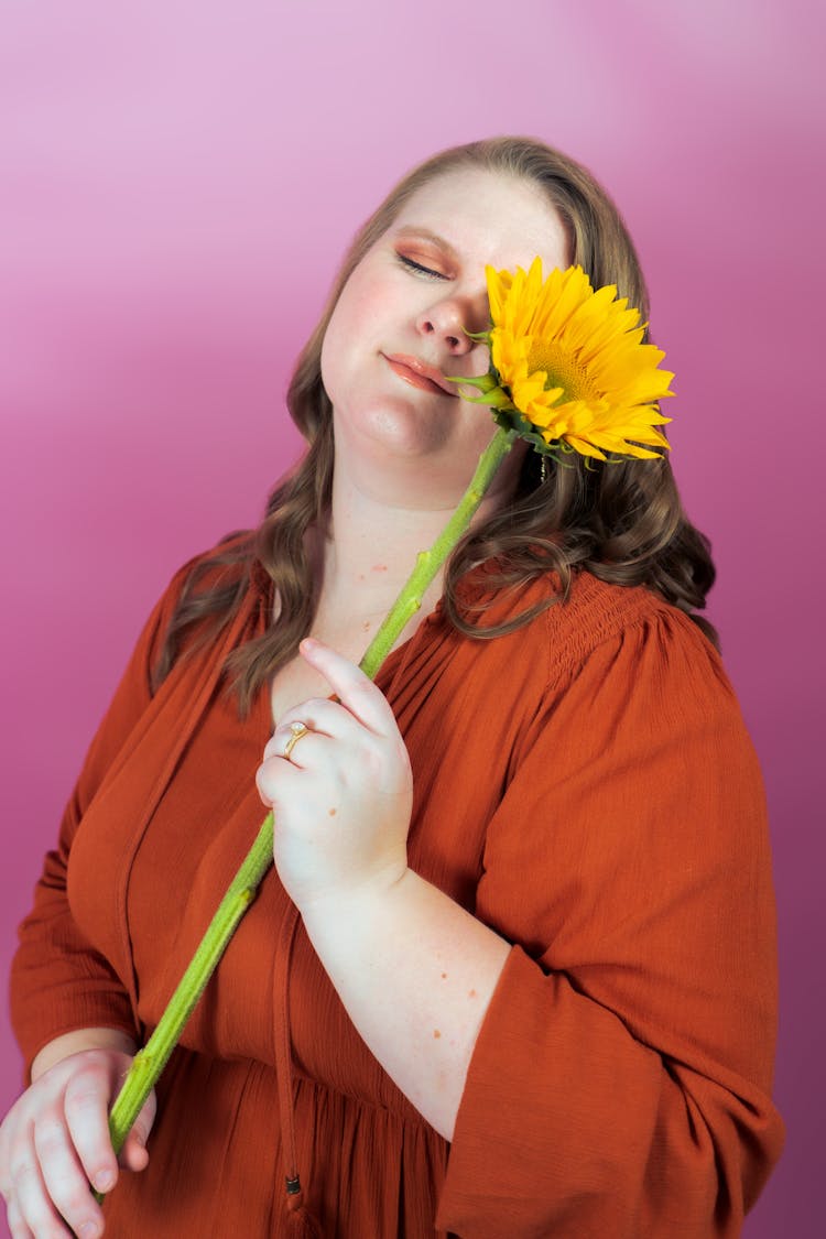 Body Positive Woman Posing With Flower In Studio