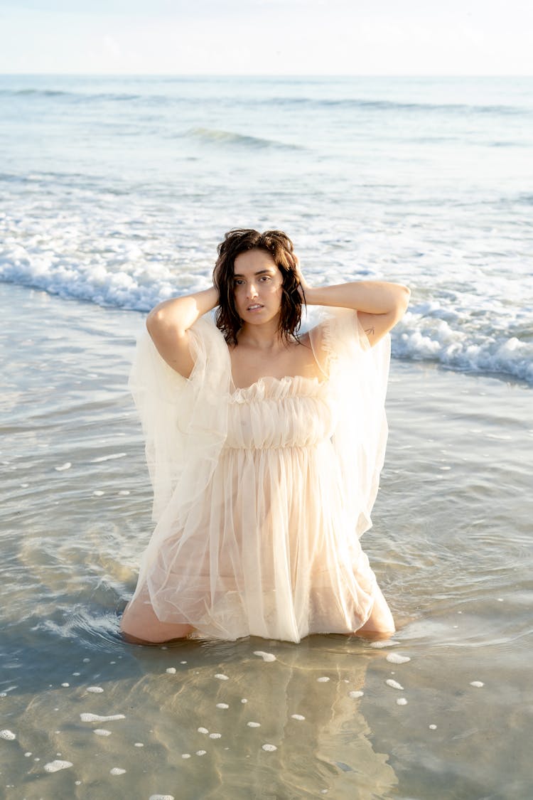 Woman In Tulle Dress Posing On Seashore