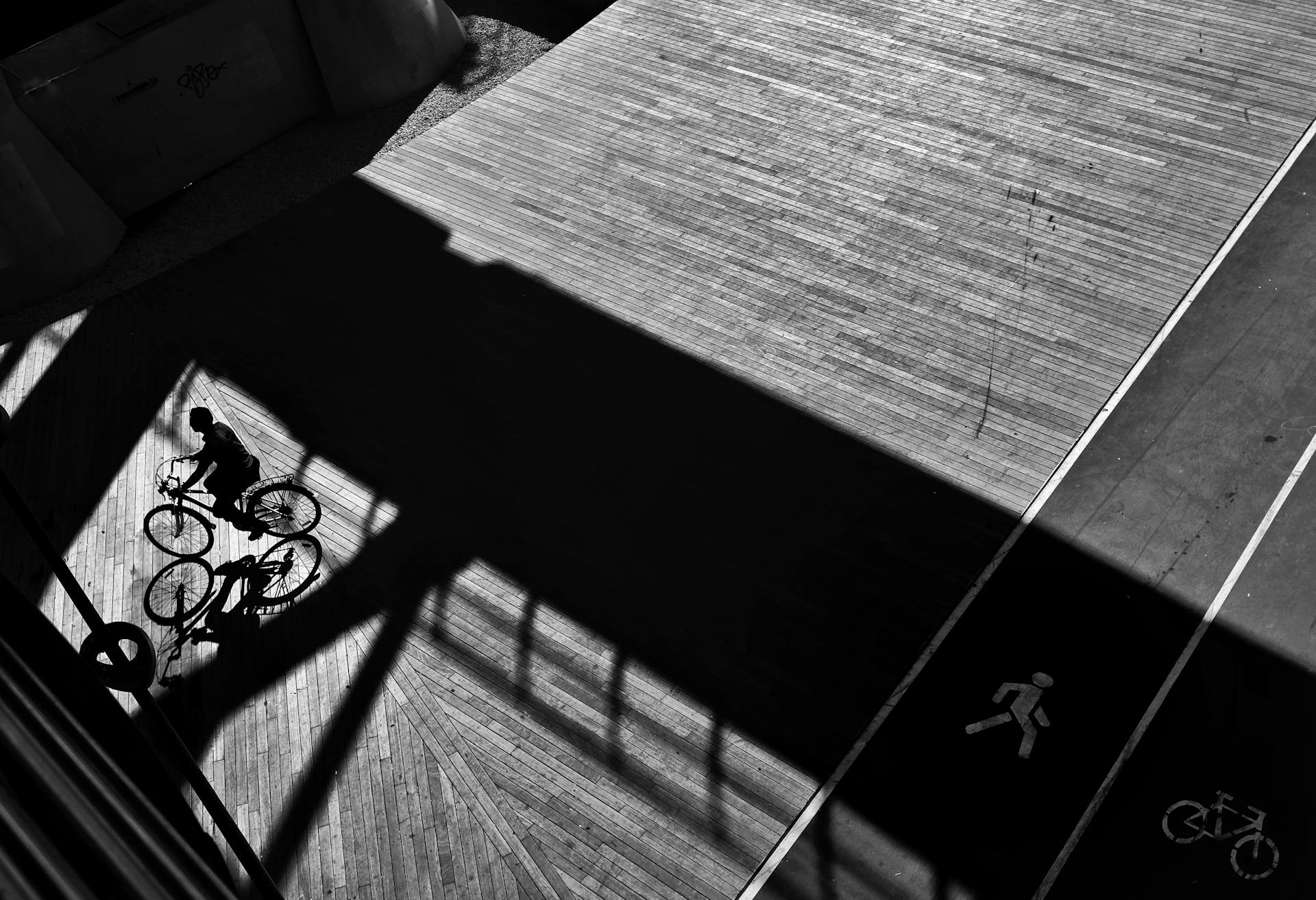 Man Riding Bike on Wooden Bridge