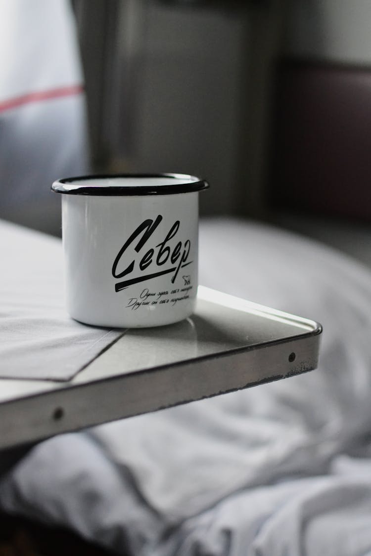 Enamel Cup On Table In Train