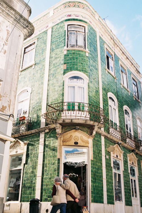 Free A picturesque green-tiled building facade in Lagos, Portugal, showcasing traditional architecture on a sunny day. Stock Photo