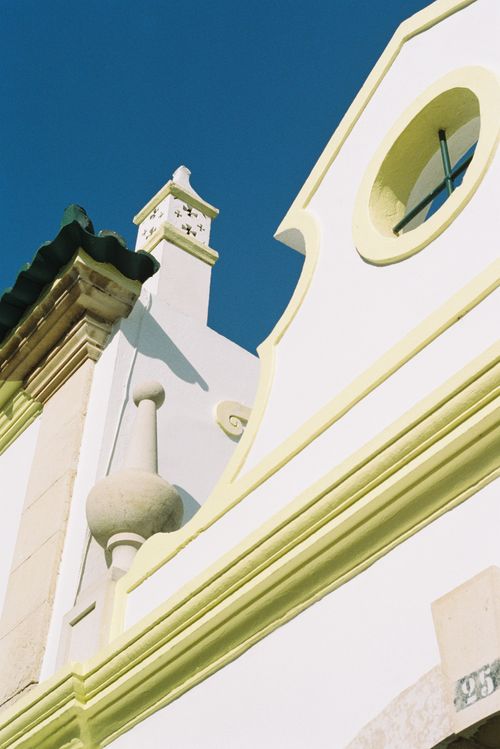 Free Low angle view of sunlit church in Faro District, Portugal showcasing historic architecture. Stock Photo