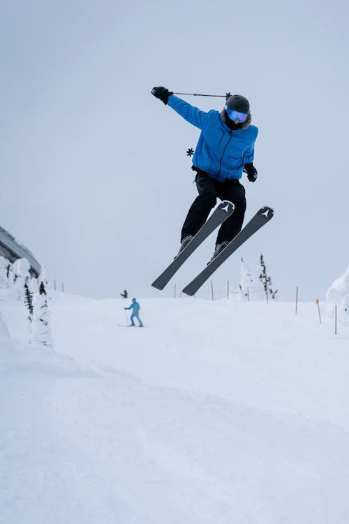 Man Jumping while Skiing on the Slope 
