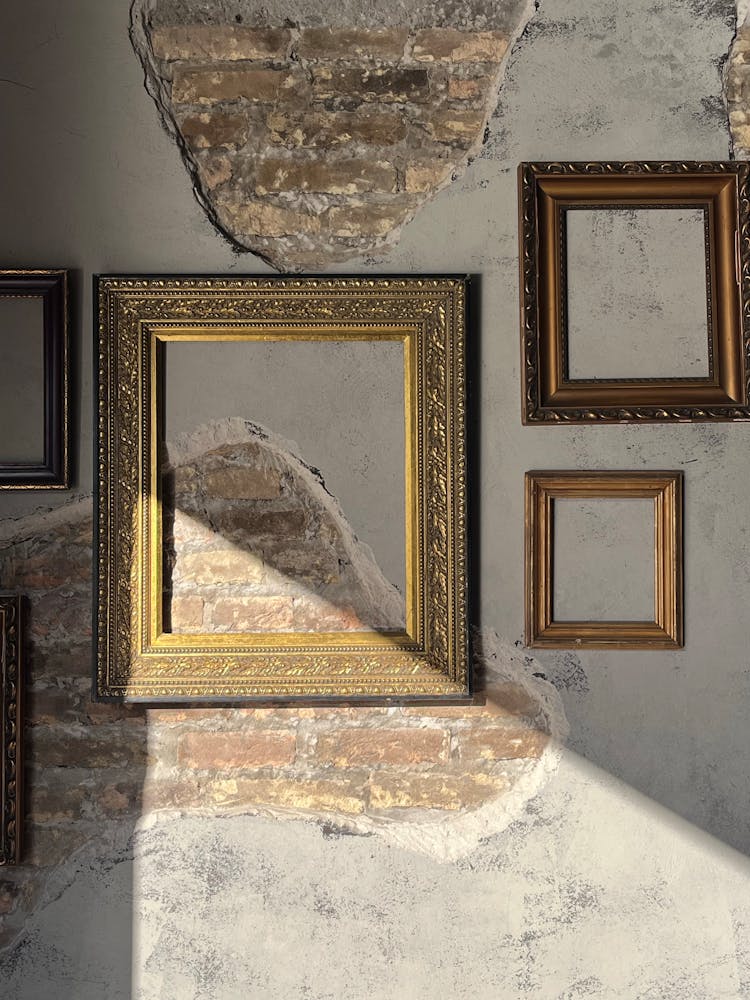 Frames Hanging On Damaged Wall