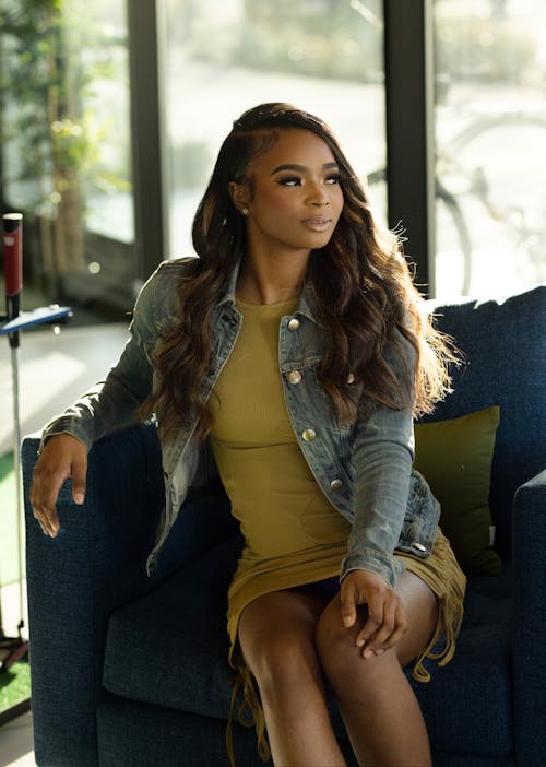 Woman in Denim Jacket Sitting on Sofa Chair