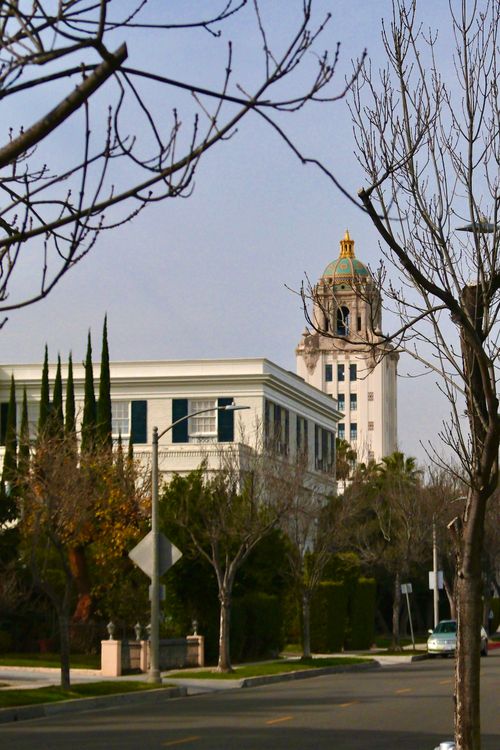 Free Beautiful view of Beverly Hills City Hall amidst urban street and trees, capturing architectural charm. Stock Photo