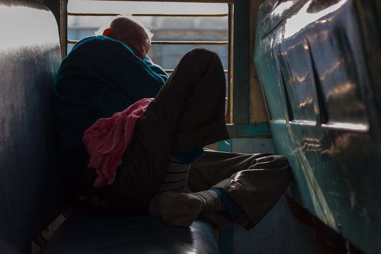 Elderly Man Sleeping Inside A Train