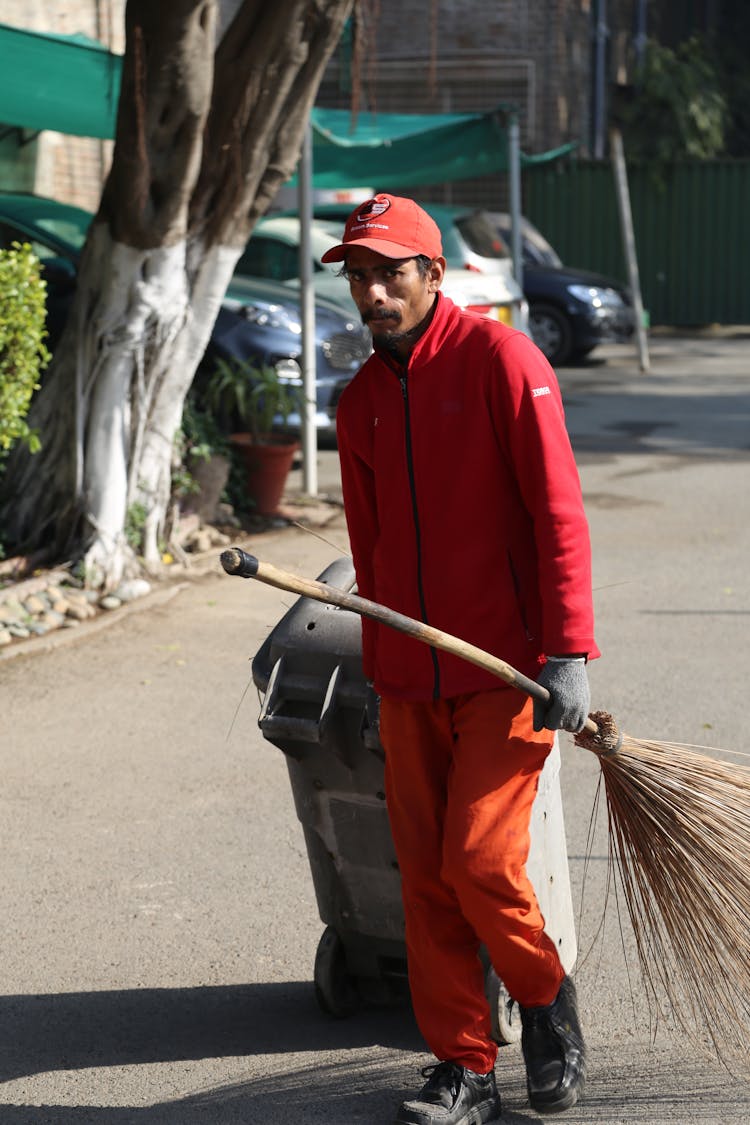 Dustman Walking With Broom