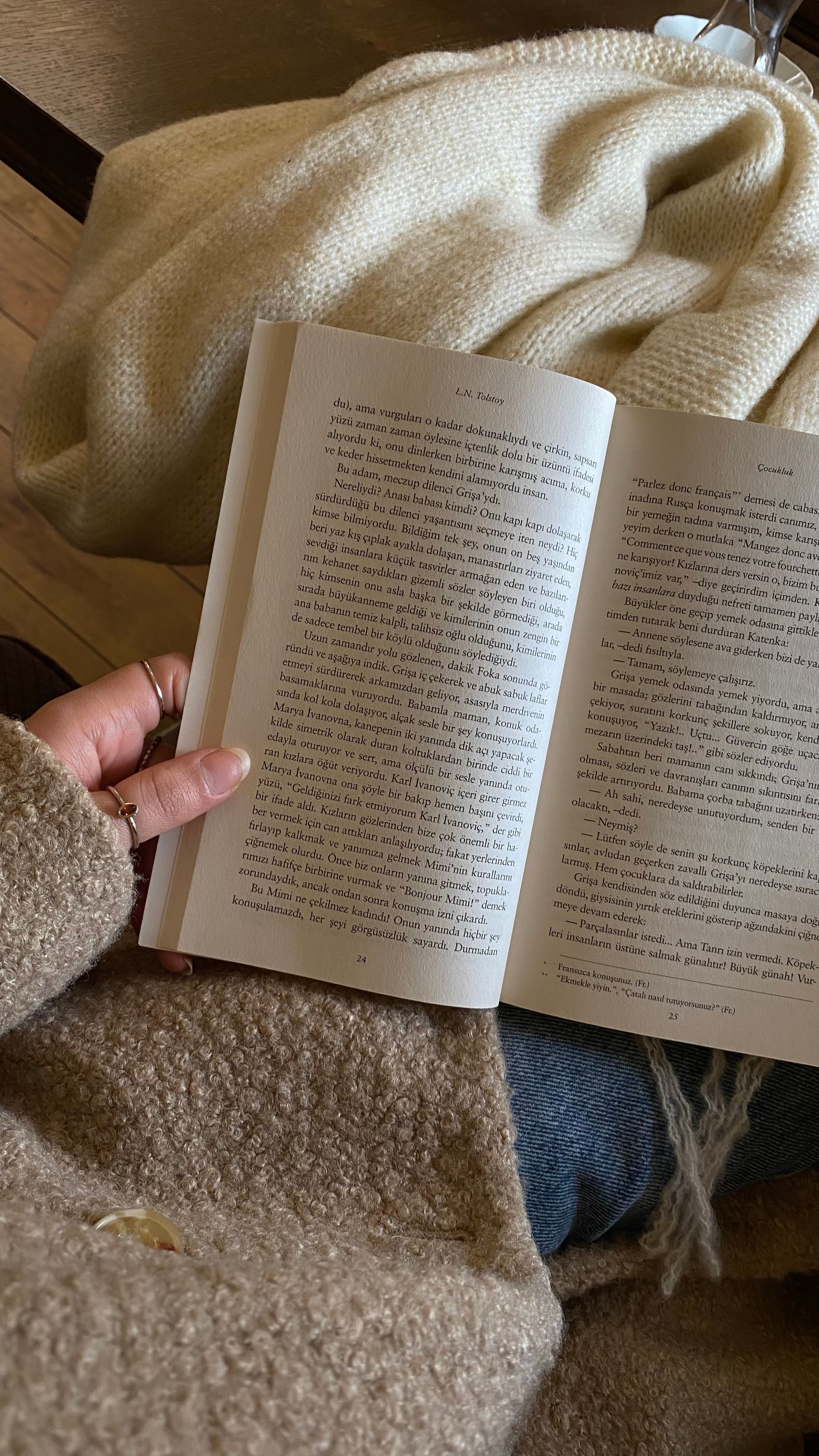A warm setting in Istanbul with an open book and blanket, ideal for reading.