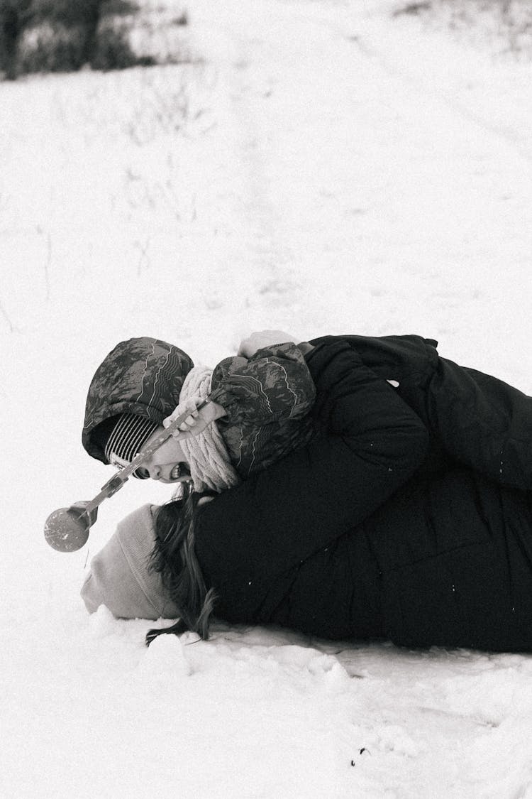 Happy Woman With Child On Snow Ground