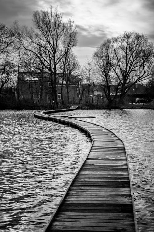 Wooden Bridge in River in Town