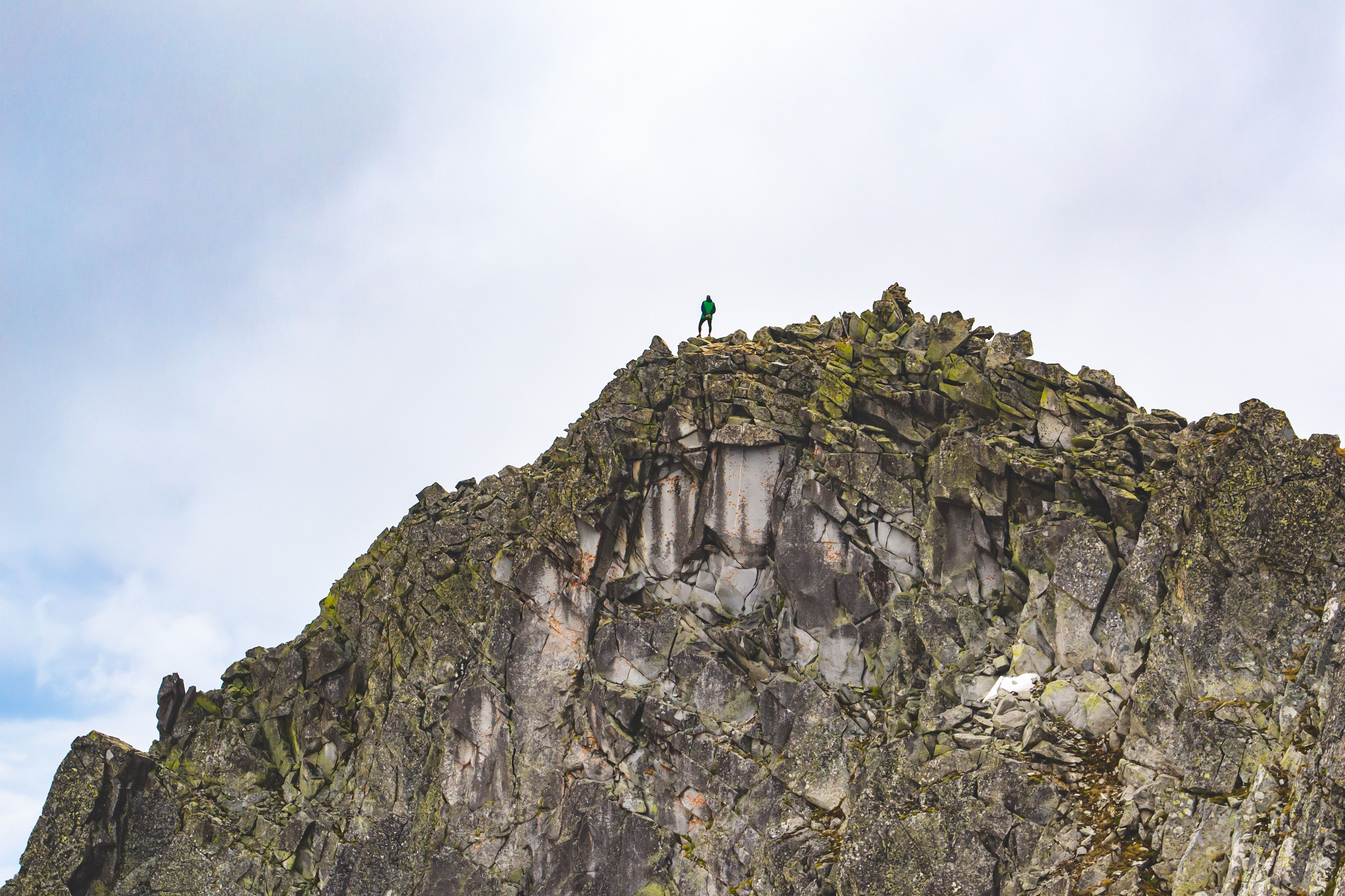 Person Standing on the Top of a Mountain · Free Stock Photo