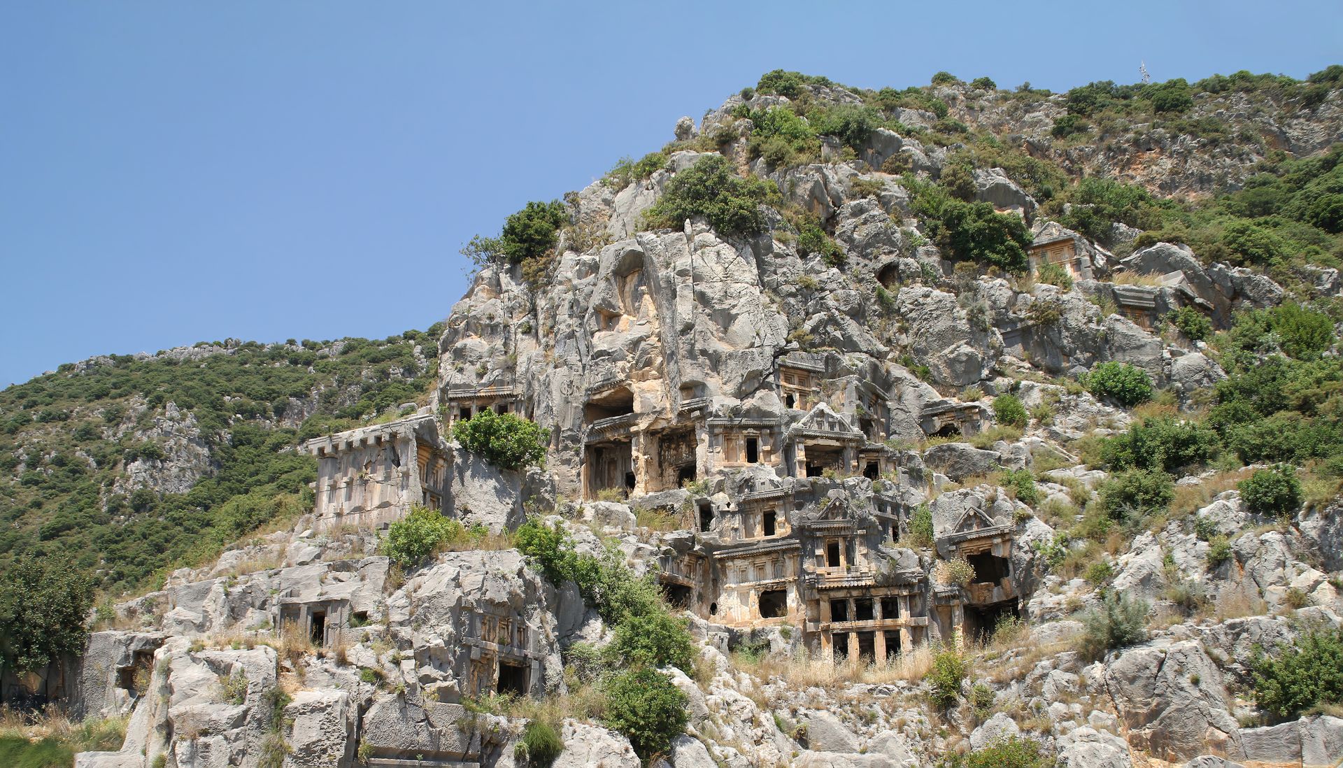 Explore the ancient Lycian tombs nestled in Turkey's stunning mountainous terrain.