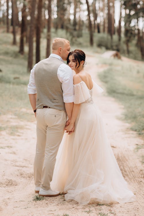 Newlyweds Posing on Footpath in Forest