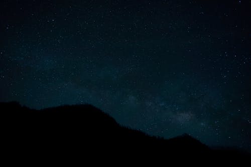 Free Clear, Night Sky with Stars over Hill Silhouette Stock Photo