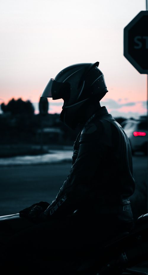 Free Dramatic silhouette of a motorcyclist riding at sunset in Casablanca, Morocco. Stock Photo