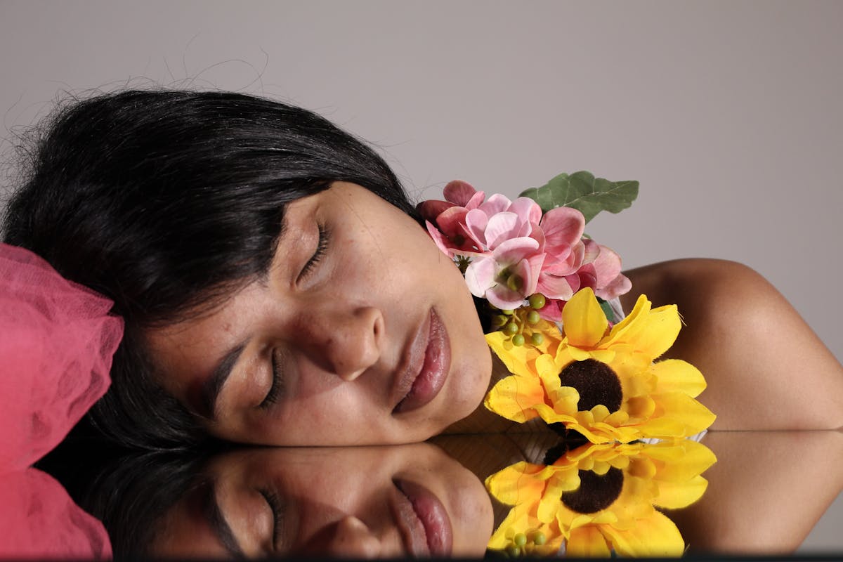 Woman Lying on a Mirror with Flowers